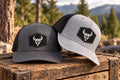 Charcoal and light gray Viking Outdoors trucker hats with helmet patches